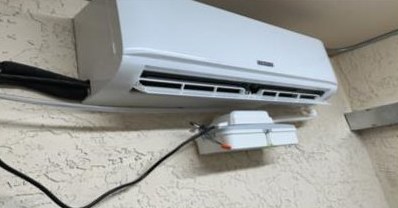 Mini split air conditioning unit installed in an elevator control room